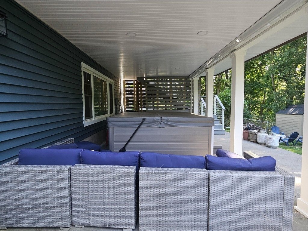 Protected lower-level lounge and hot-tub area beneath the dry-below ceiling.