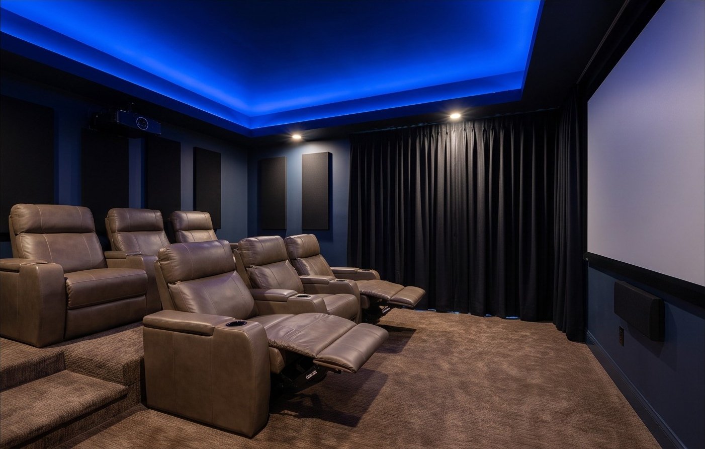 Dedicated home theater with tiered seating and blue perimeter lighting.