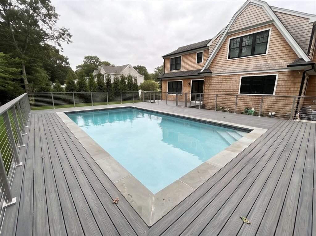 Pool-Surround Deck in Monmouth County, NJ Wide view of the composite pool-surround deck and bluestone coping.