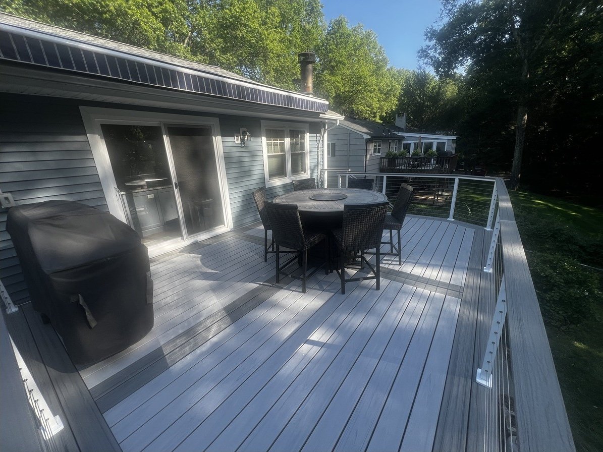 Wide view of the completed single-story deck running along the rear of the home.